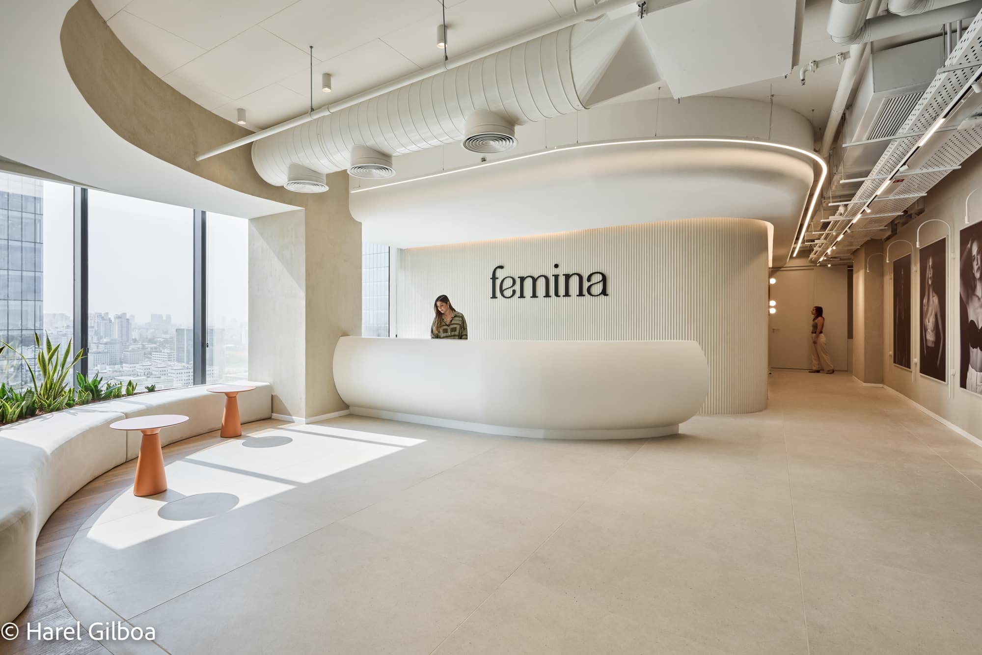 femina 3D logo on a curved fluted reception desk wall