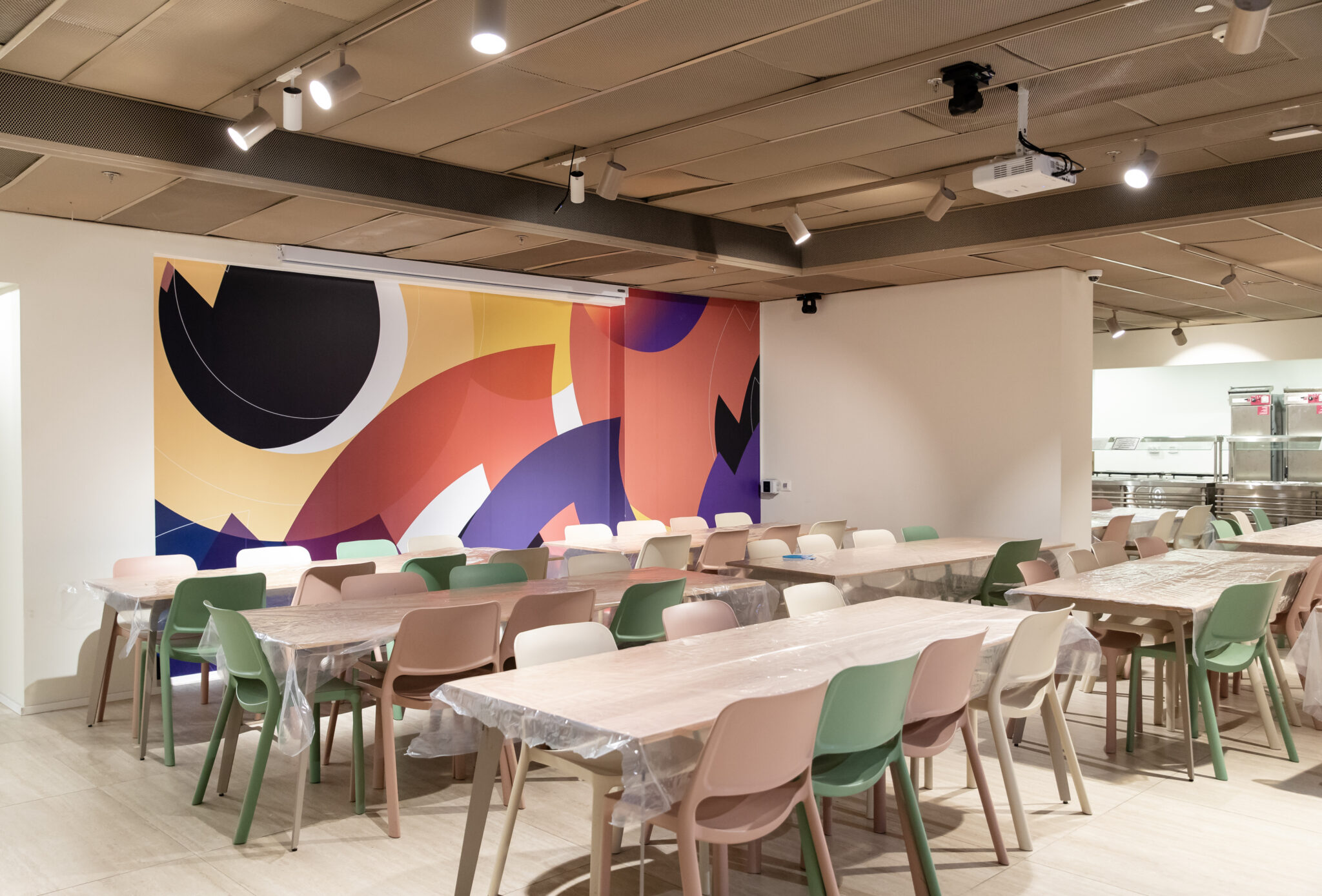 Large colour block mural filling the dining hall wall