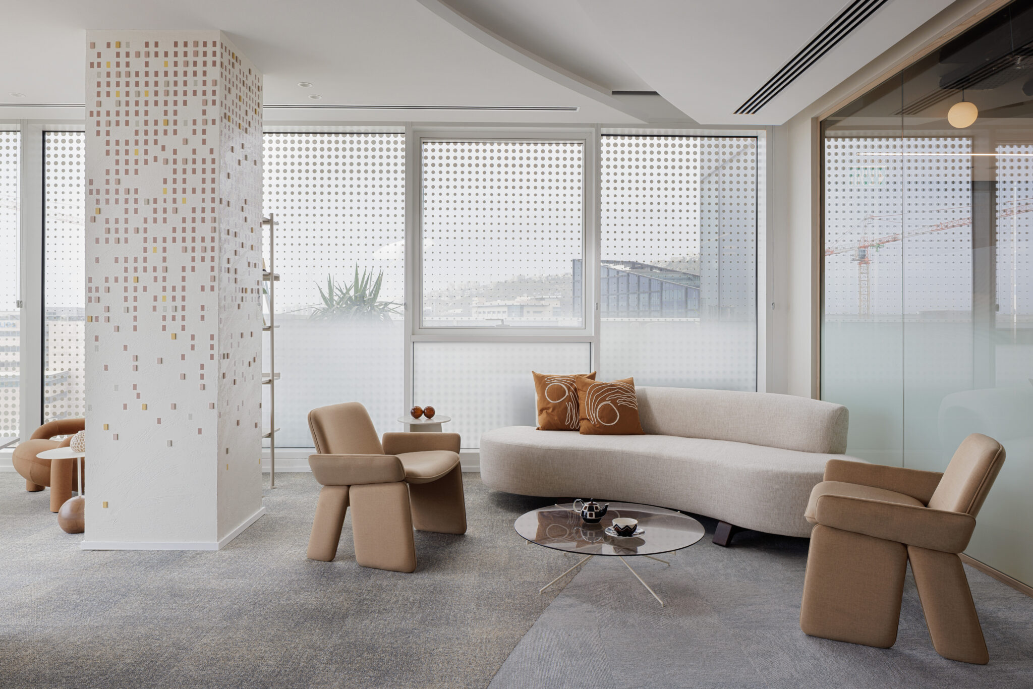 Lounge with curved sofa and a column with a pixel graphic
