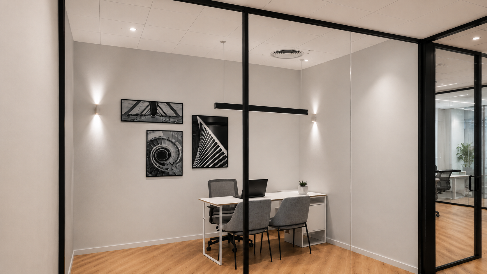 Small office with framed black and white architecture prints