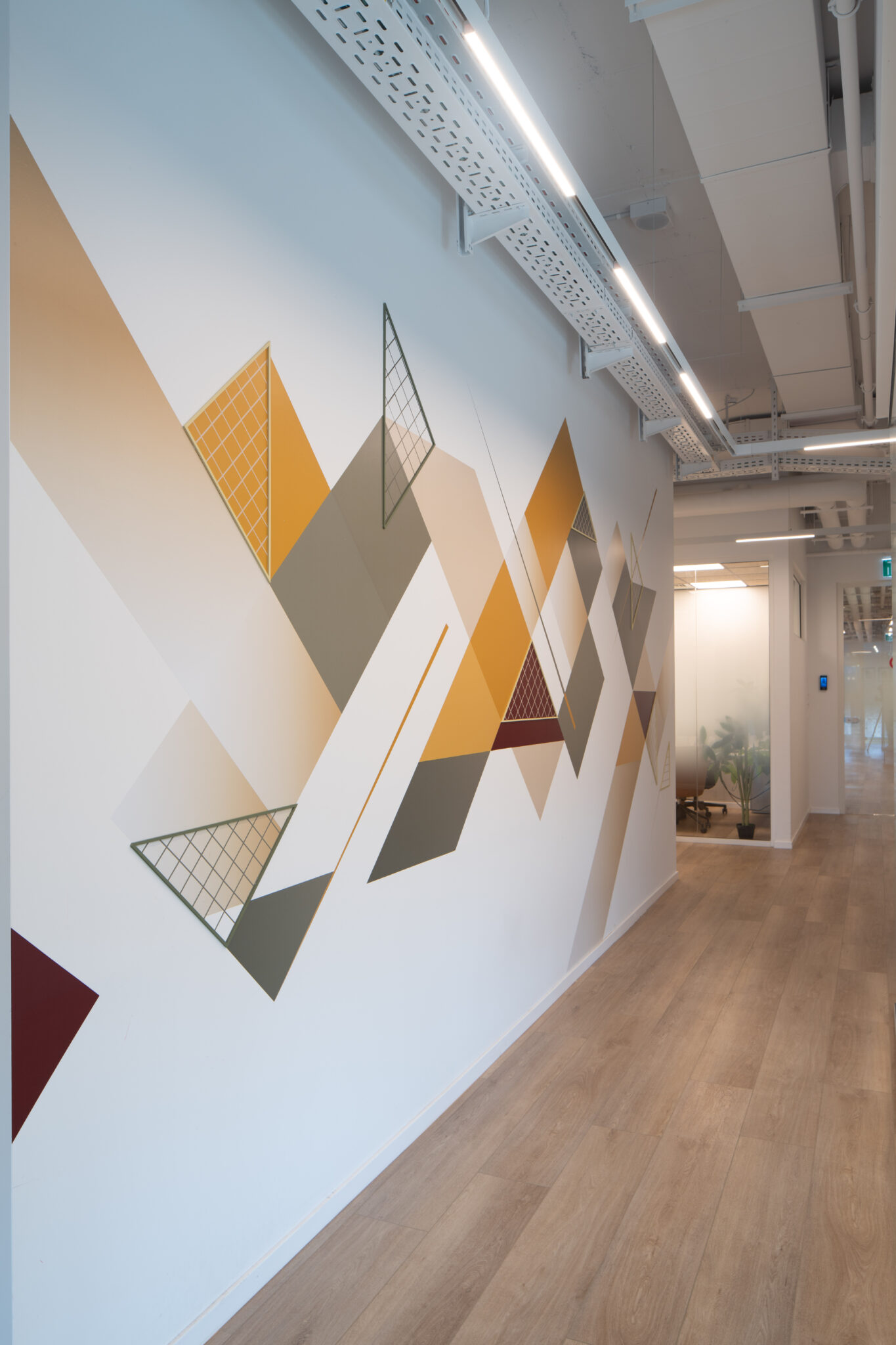 Corridor wall with orange and grey geometric triangle graphic