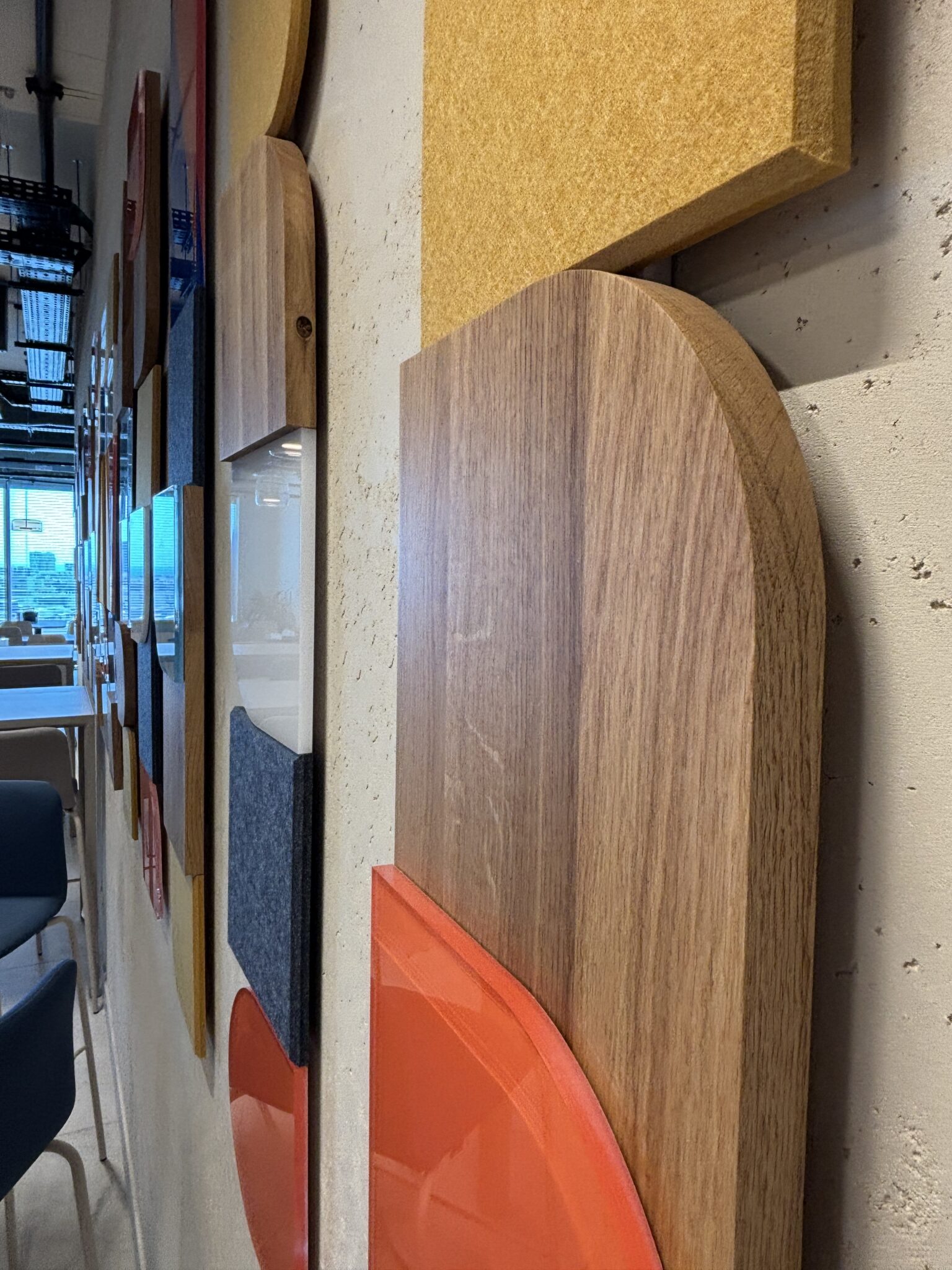 Close-up of layered wood, felt and orange wall panels