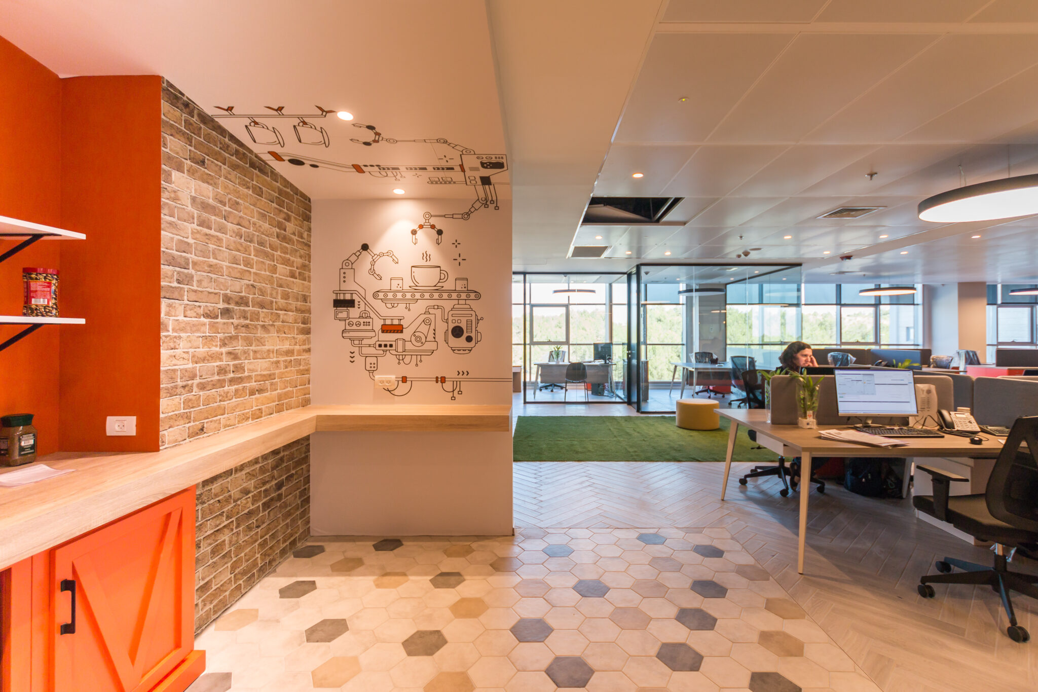 Brick wall with a line-drawing graphic and orange cabinets