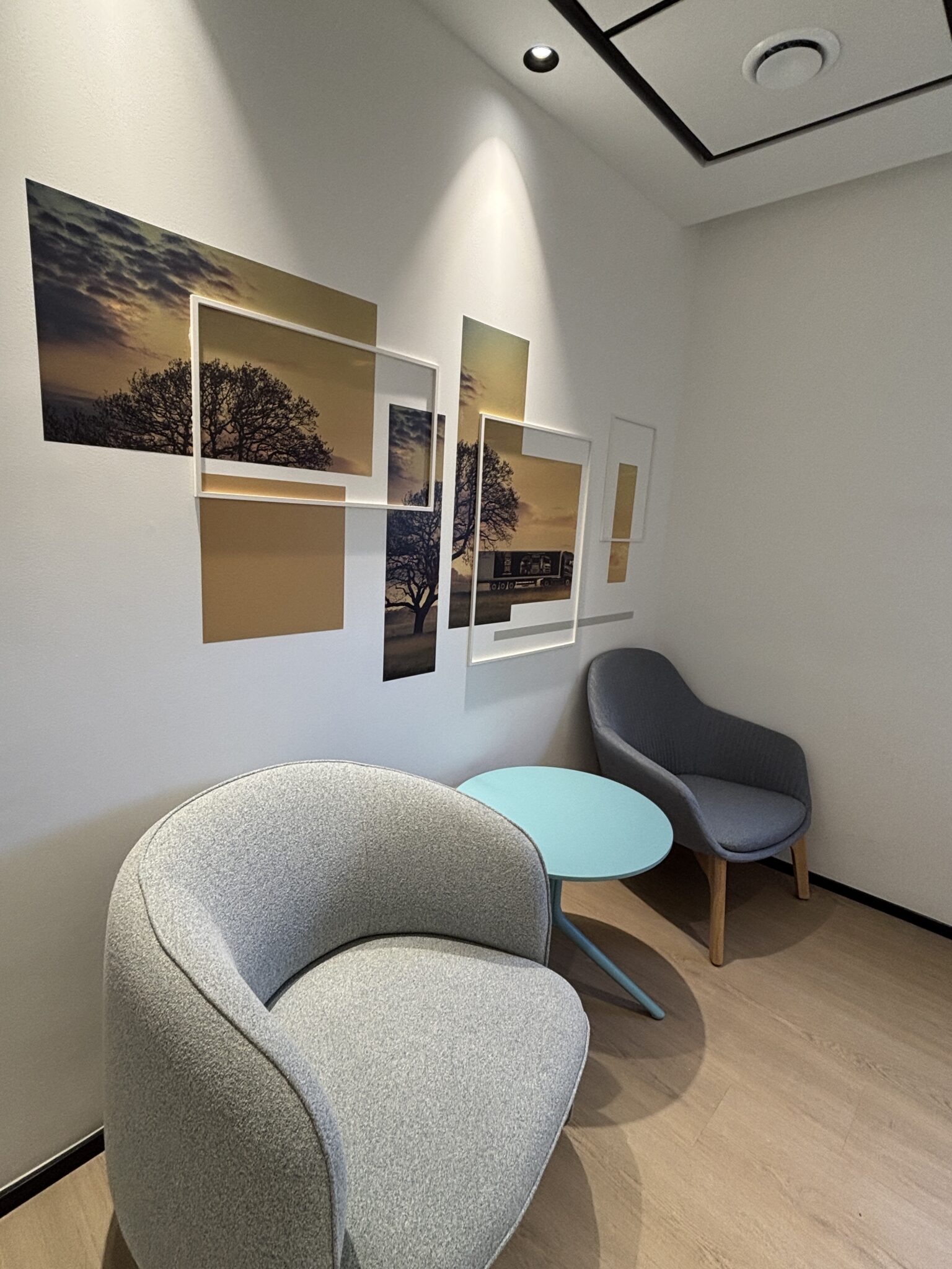 Seating corner with layered framed landscape photos