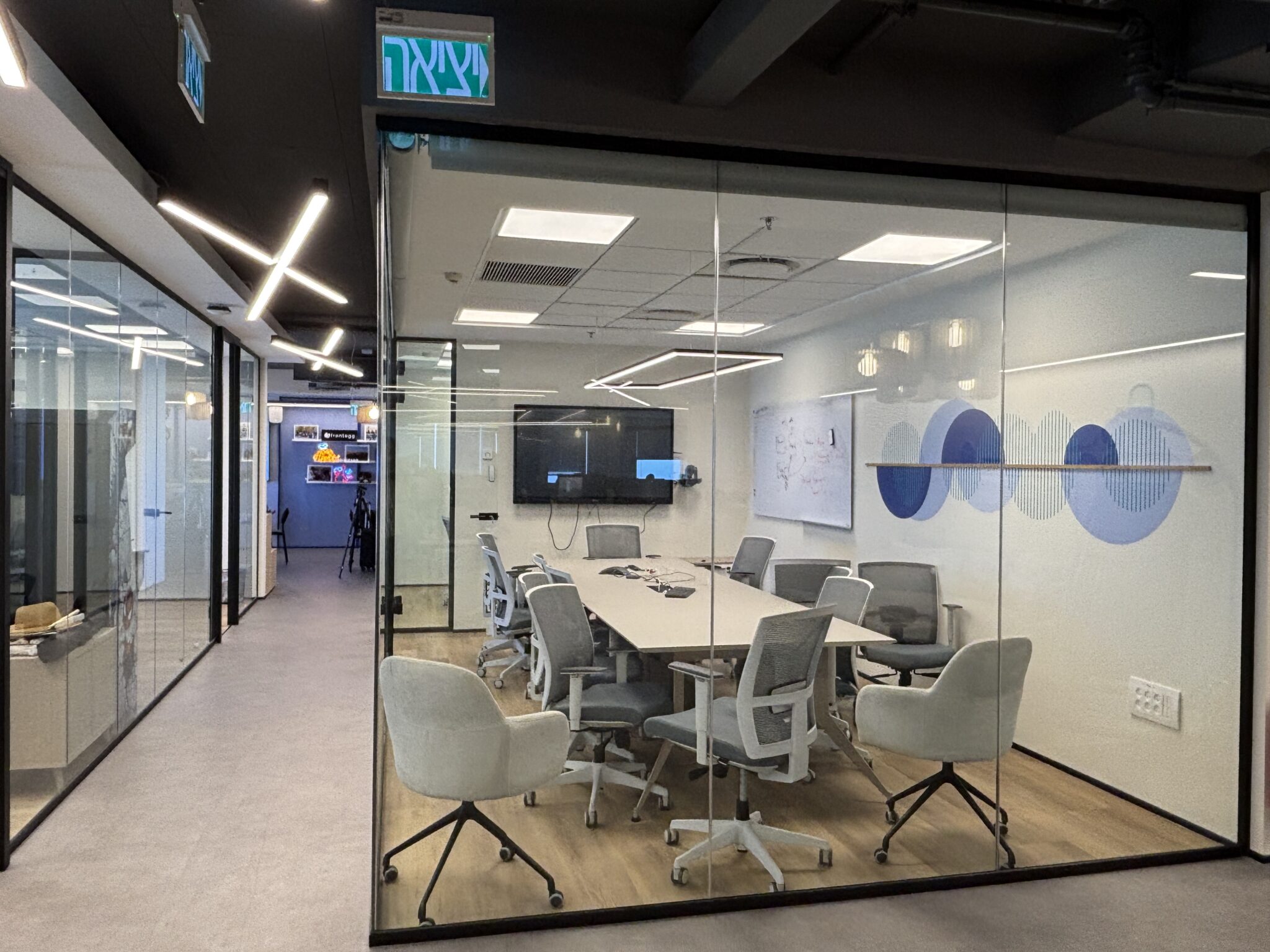 Glass boardroom with a blue circle wall graphic