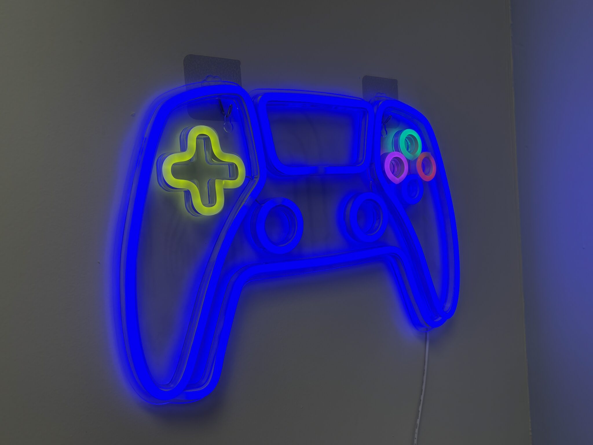 Blue game controller neon sign on a wall