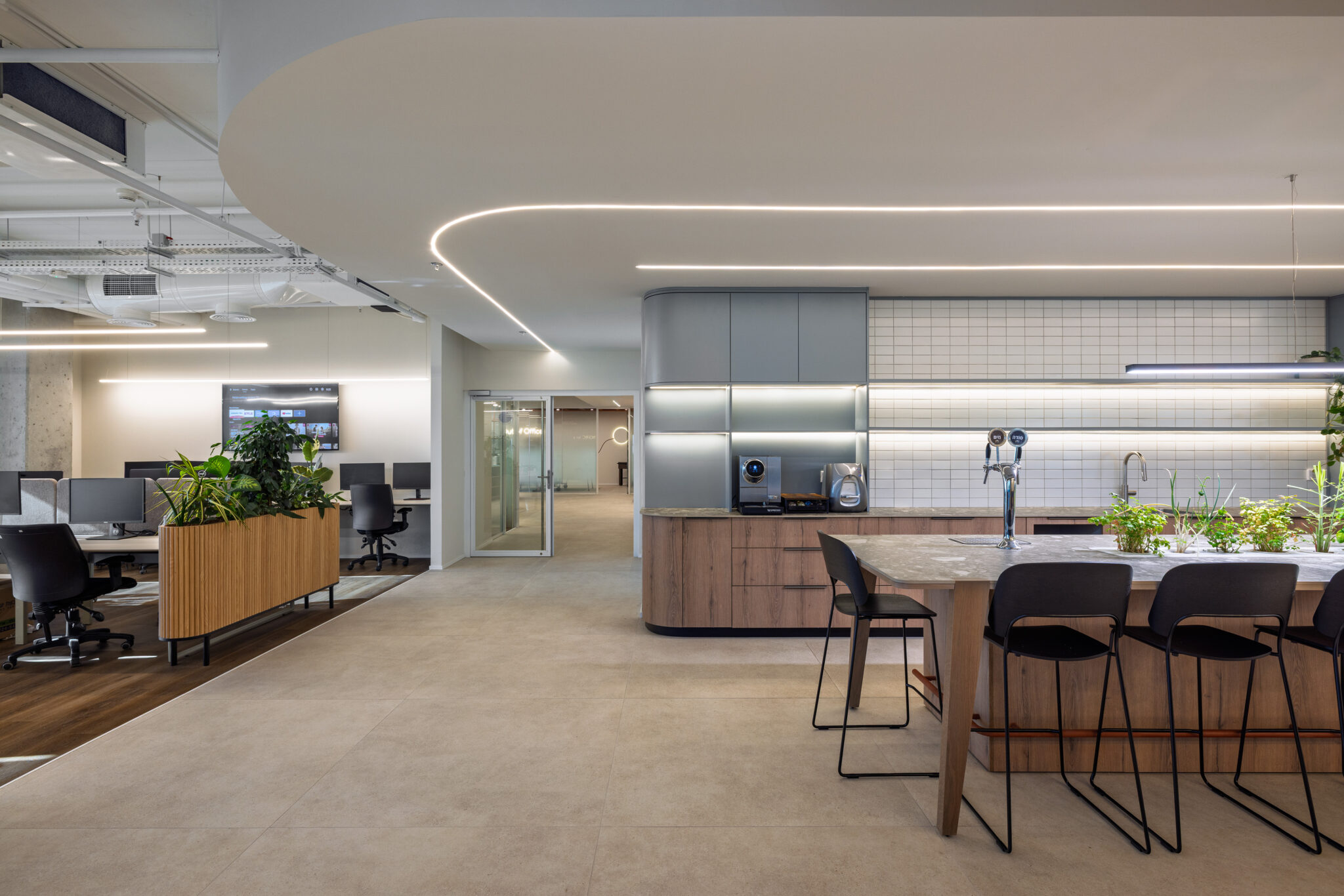 Open kitchen and dining island beside an open workspace