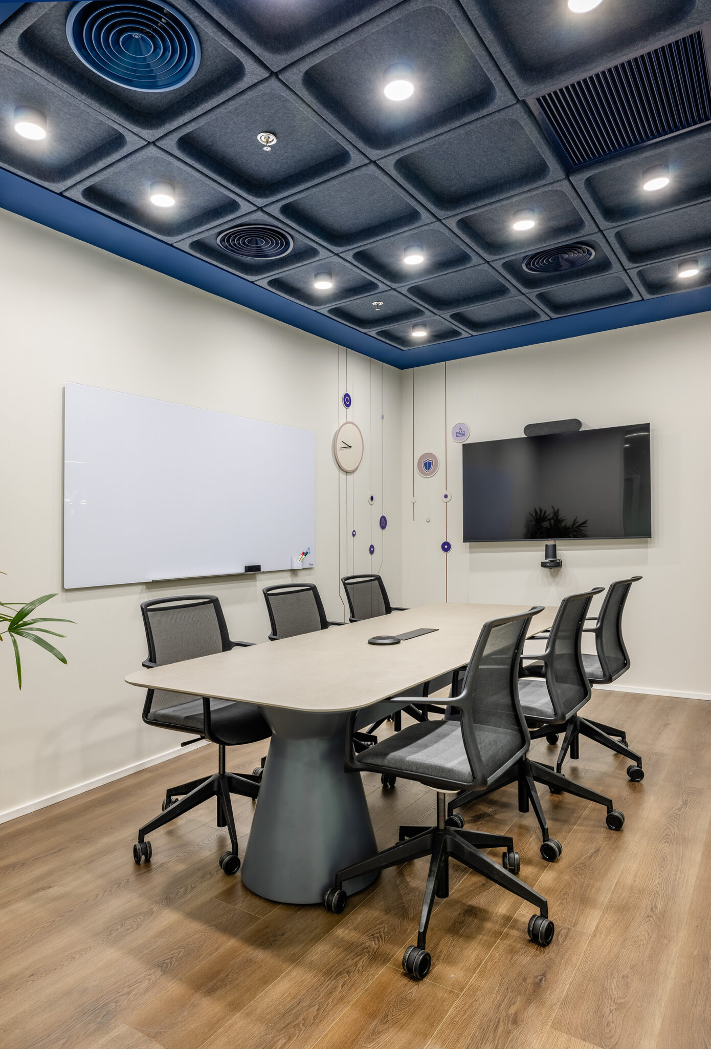 Meeting room with whiteboard and a dark coffered ceiling