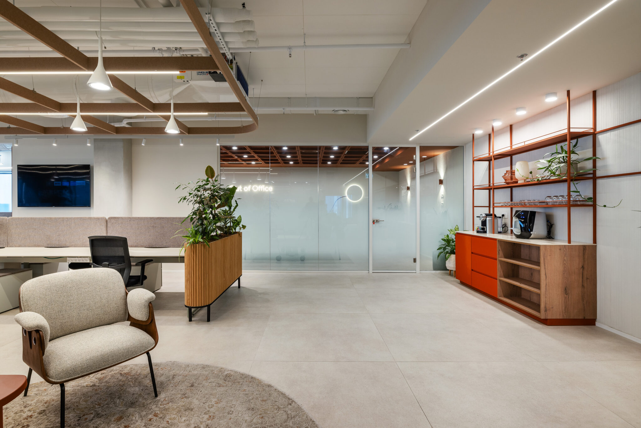 Workspace with orange shelving unit and frosted glass rooms