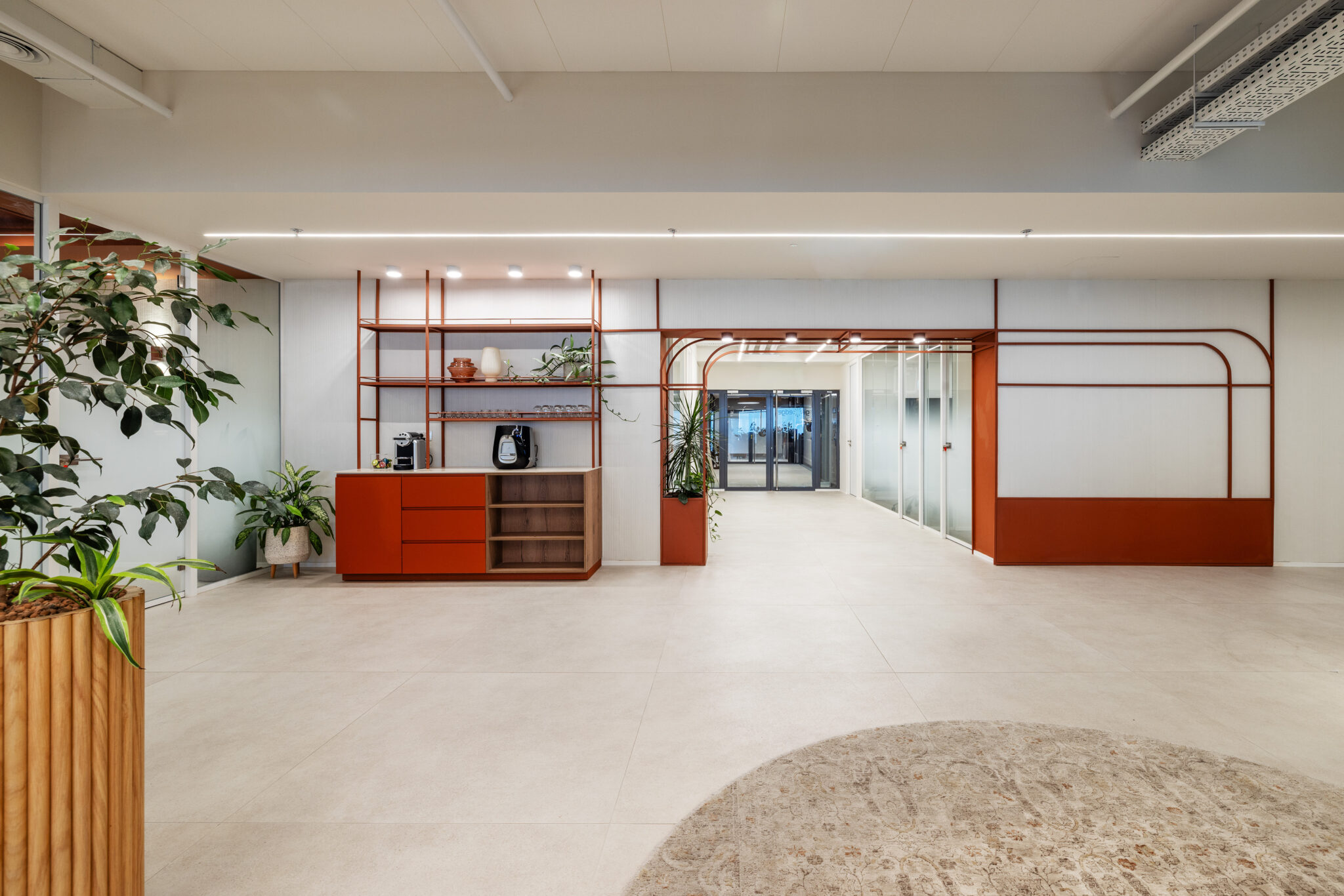 Open area with orange shelving and an arched orange frame