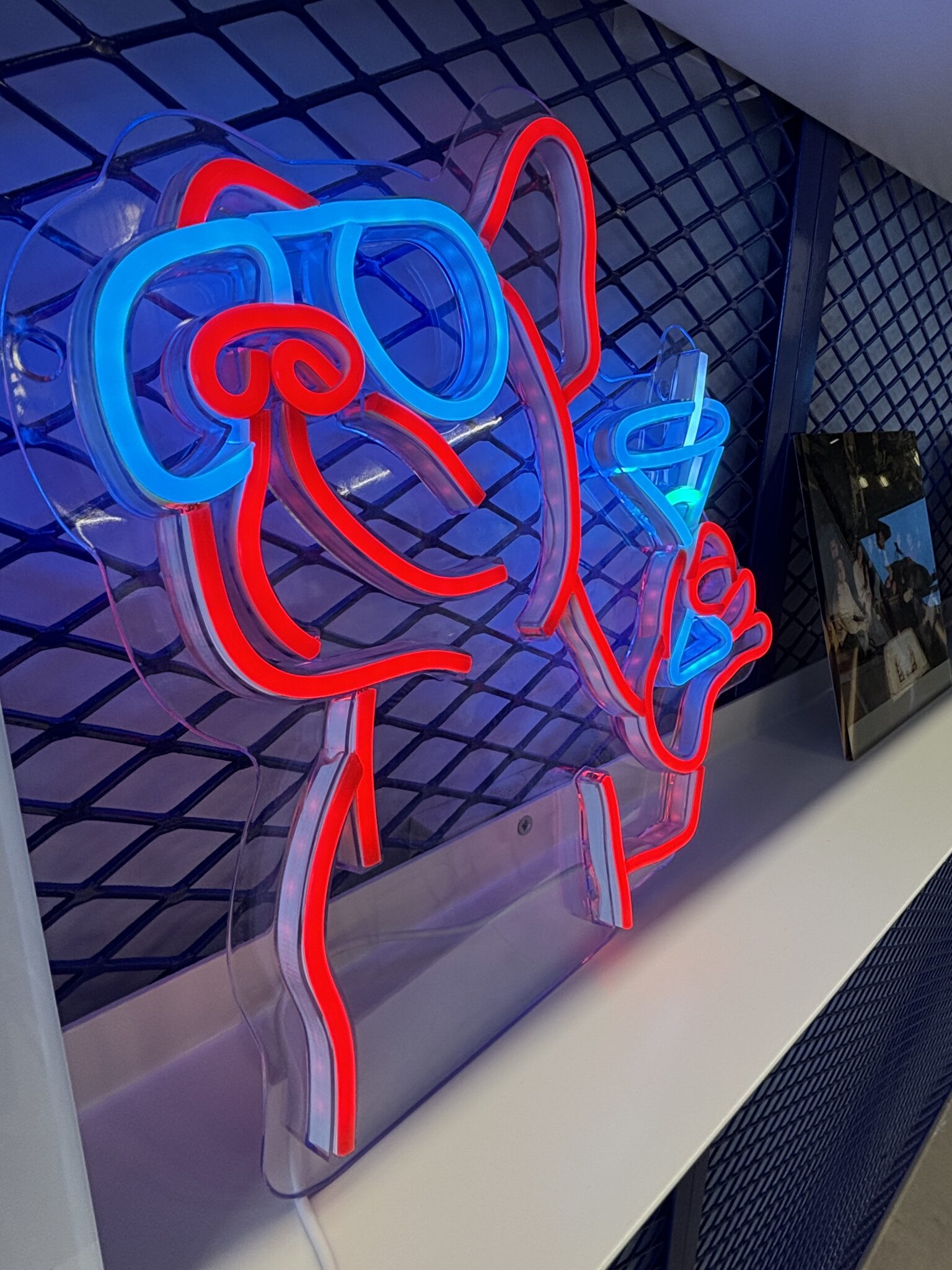 Red and blue neon dog sign on a shelf