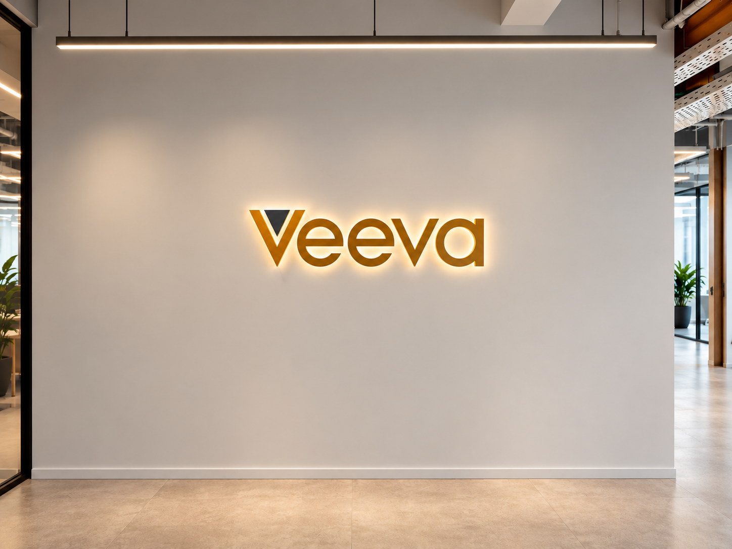 Veeva backlit logo on a white wall