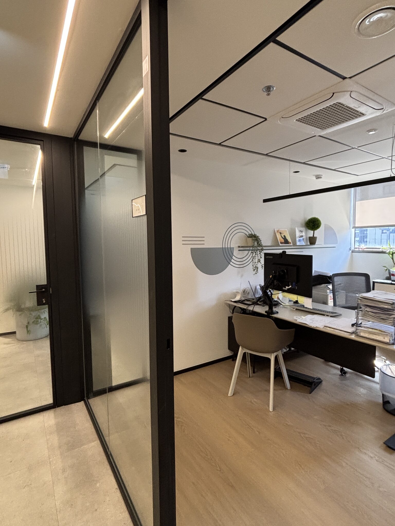 Glass office with a circle line art wall graphic