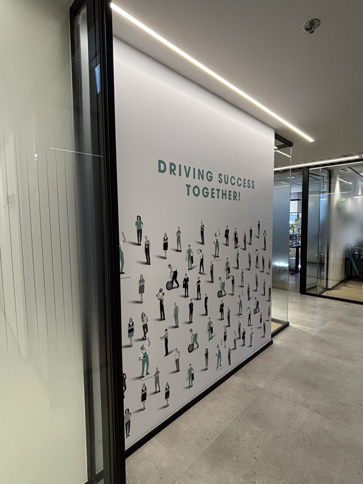 DRIVING SUCCESS TOGETHER wall graphic with small people figures