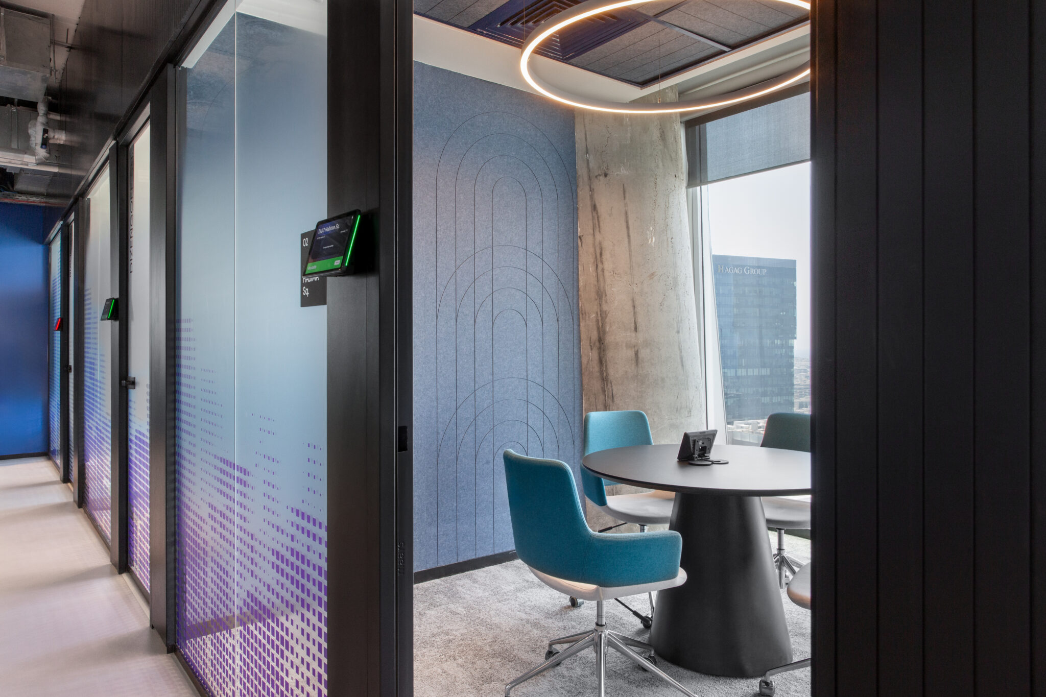 Meeting room with blue gradient film and teal chairs