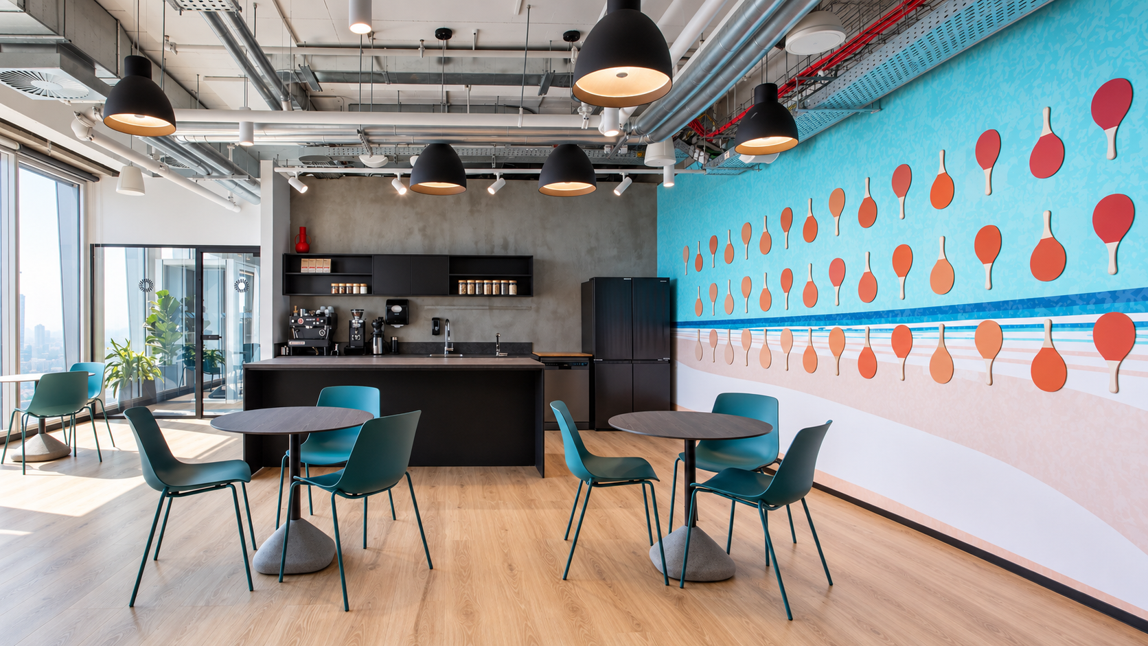 Cafe area with teal chairs and a ping pong paddle wall mural