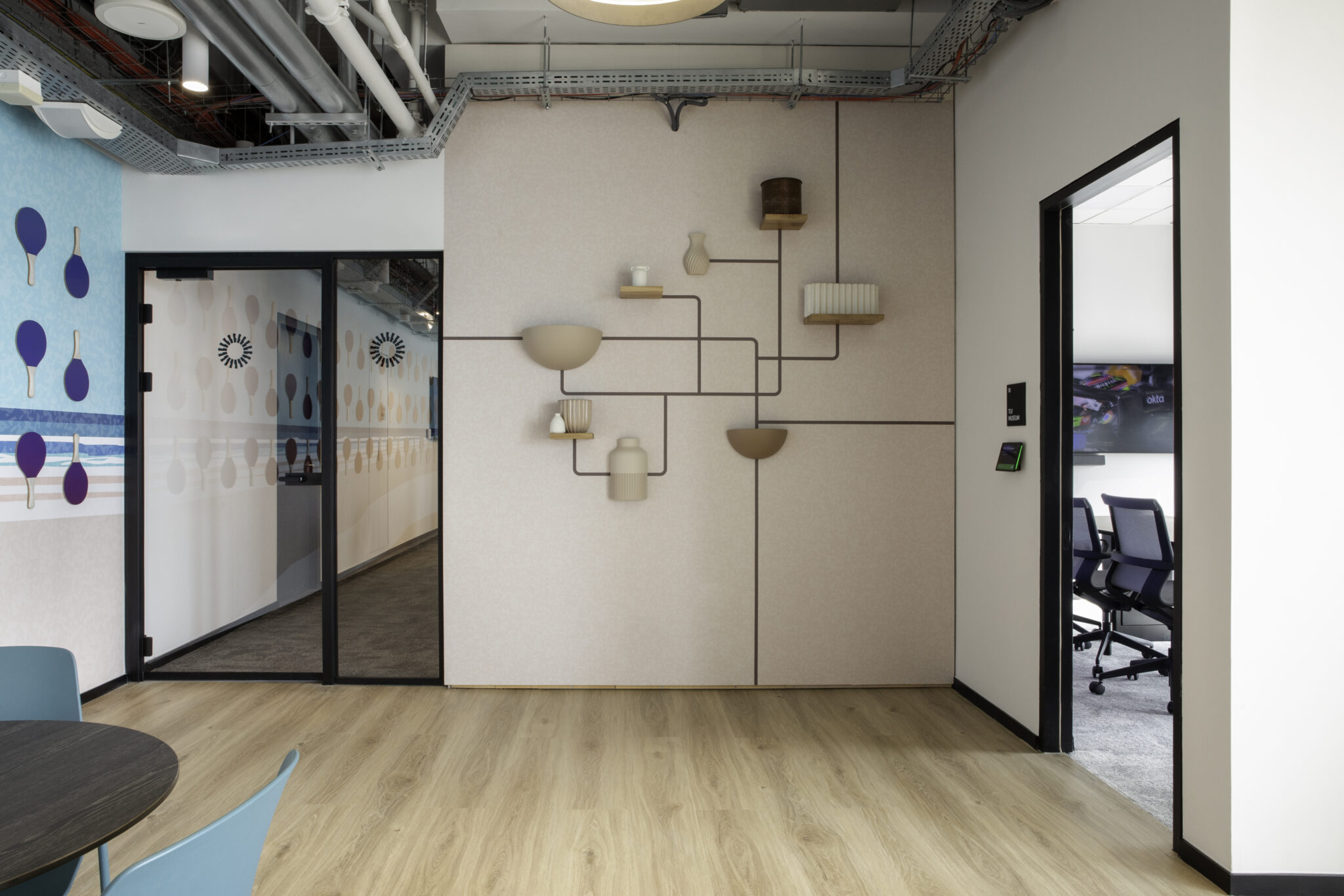 Wall with line art shelves holding vases and bowls