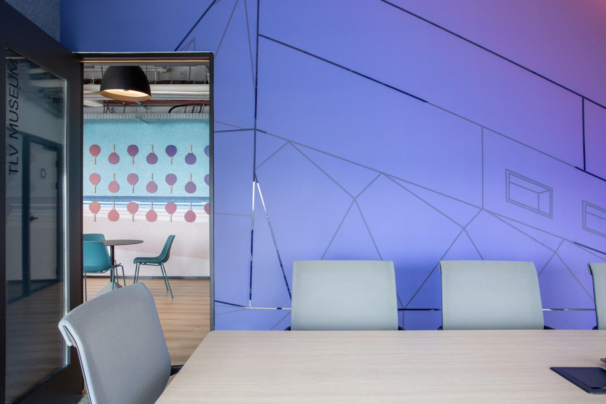 Meeting room with blue and purple geometric line wall graphic