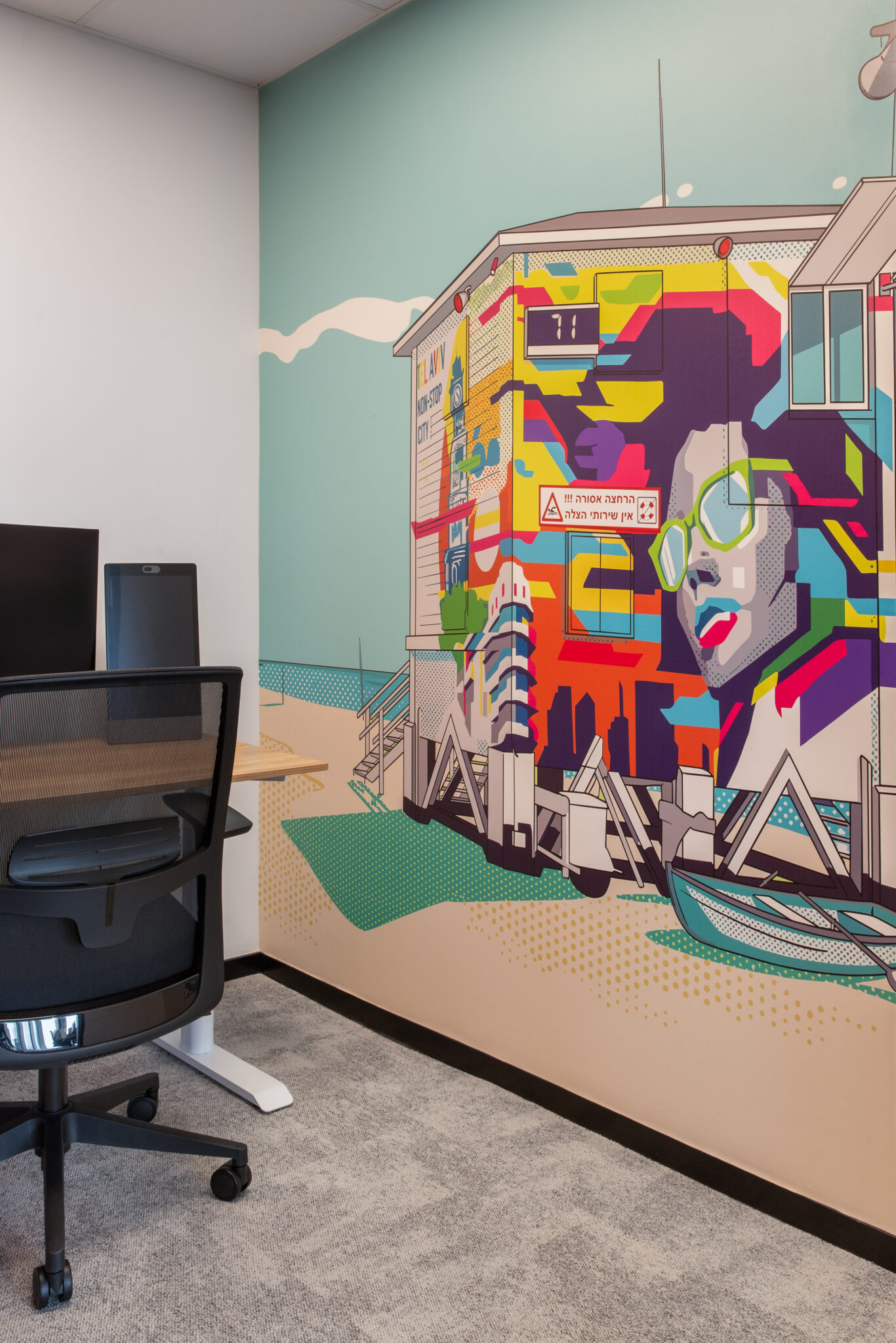Pop art building illustration mural beside a workstation