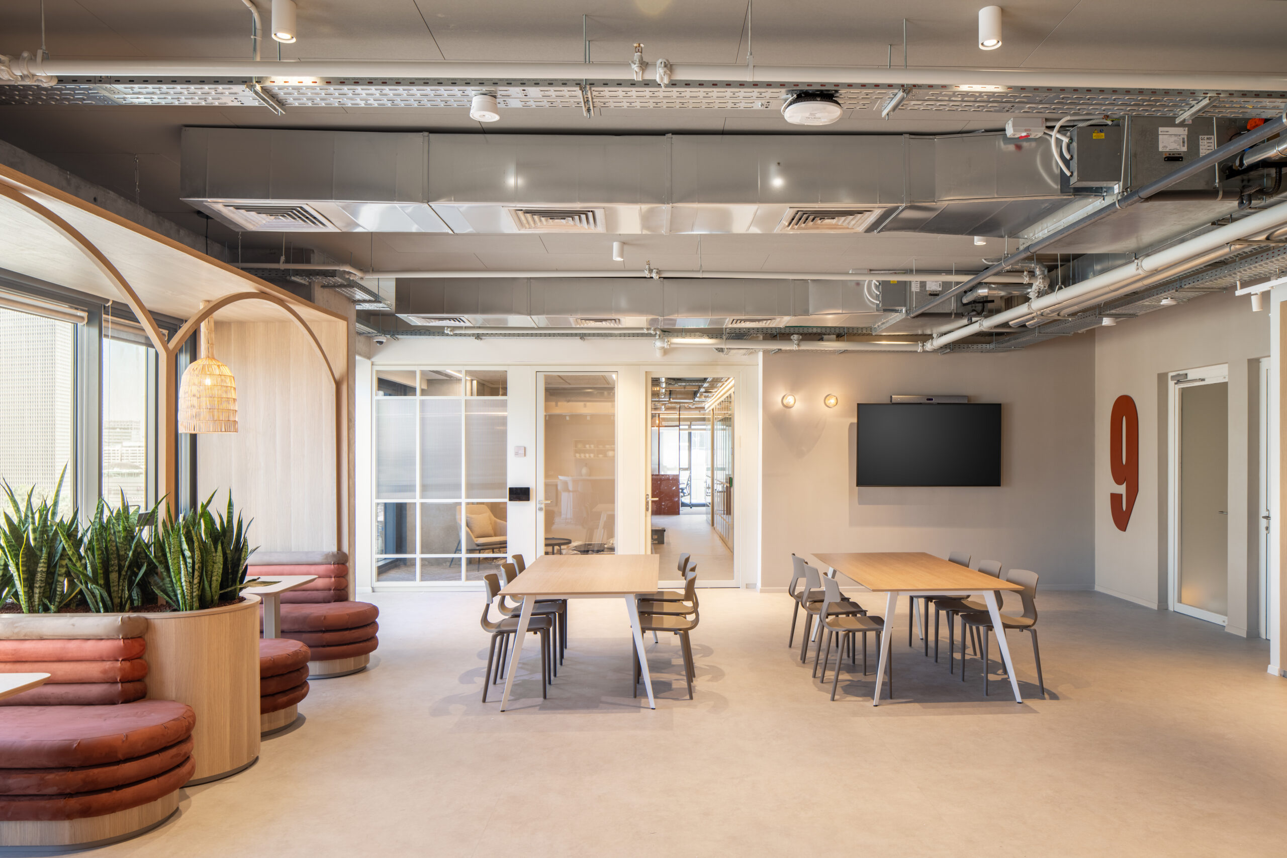 Open space with long tables, a TV and a large number 9