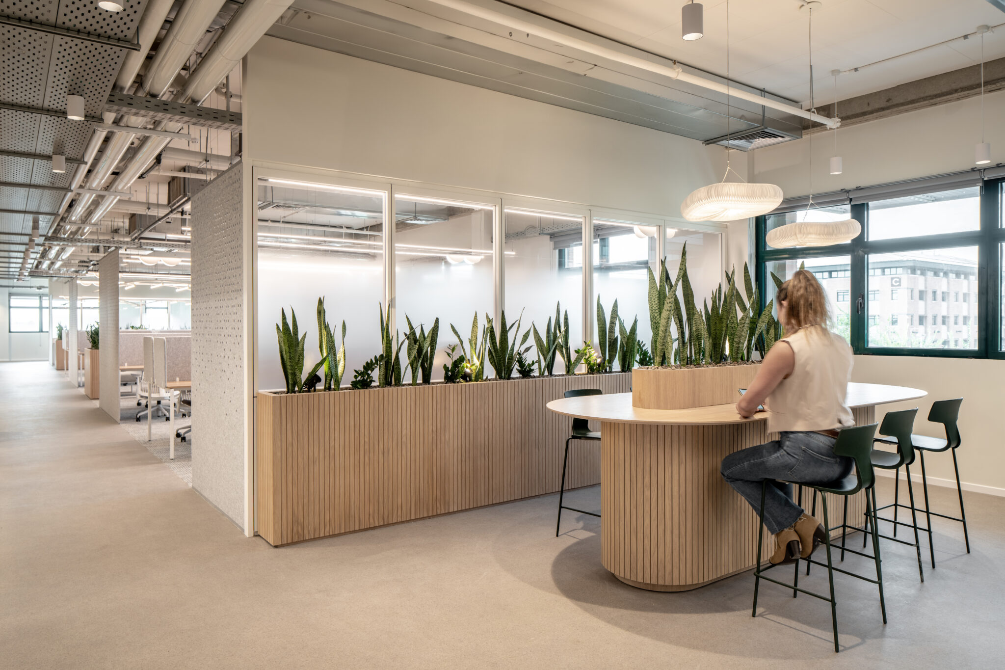 Wood-slat planter bar with plants and high stools