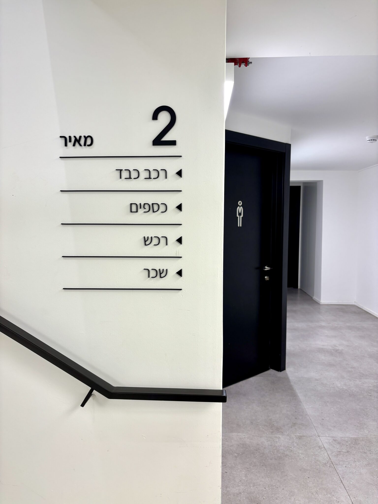 Hebrew floor directory sign for floor 2 by a stairwell
