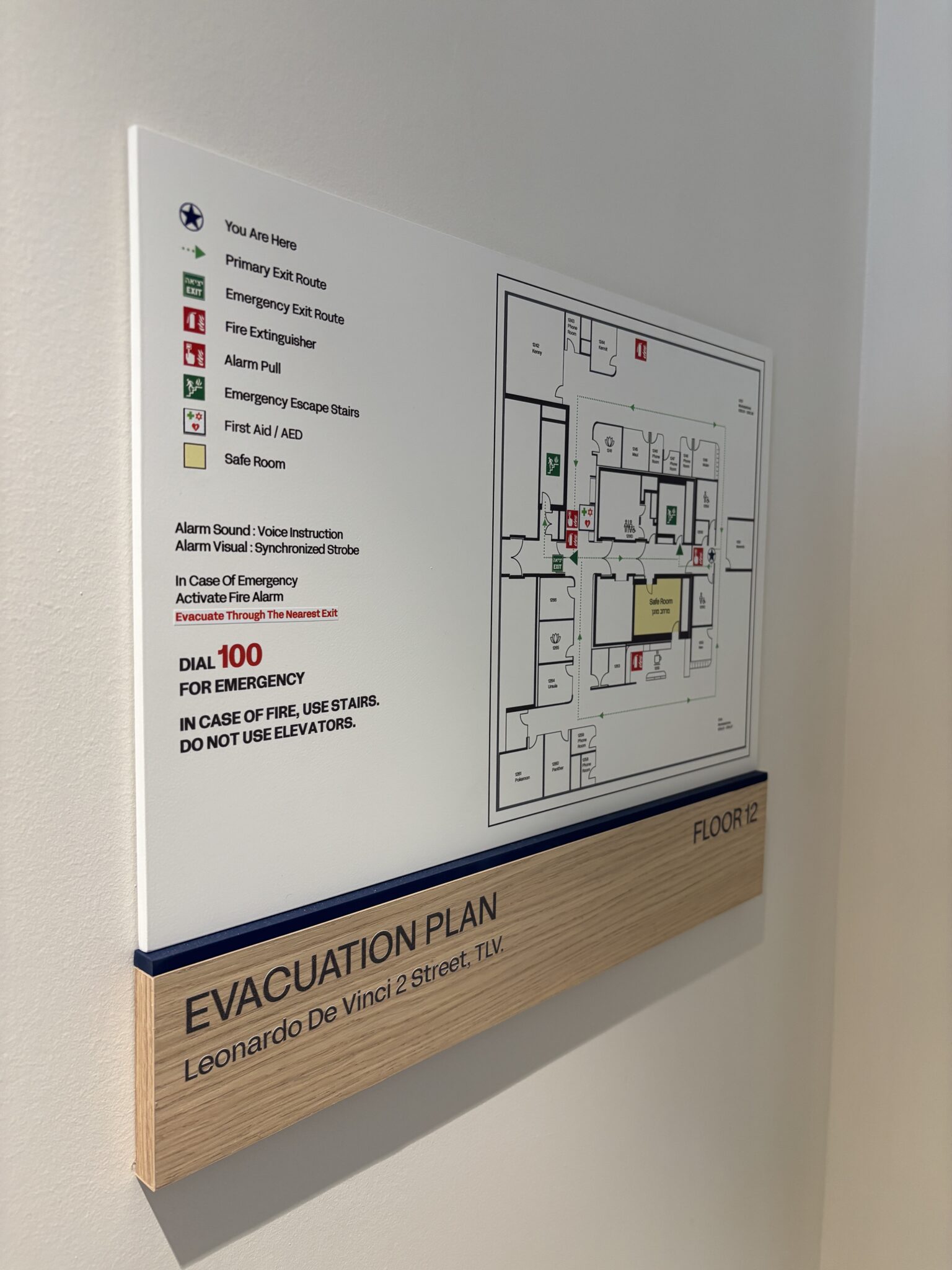 Evacuation plan sign with floor map on a wood base