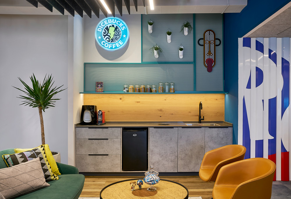 Kitchenette with a round neon coffee sign and colourful walls