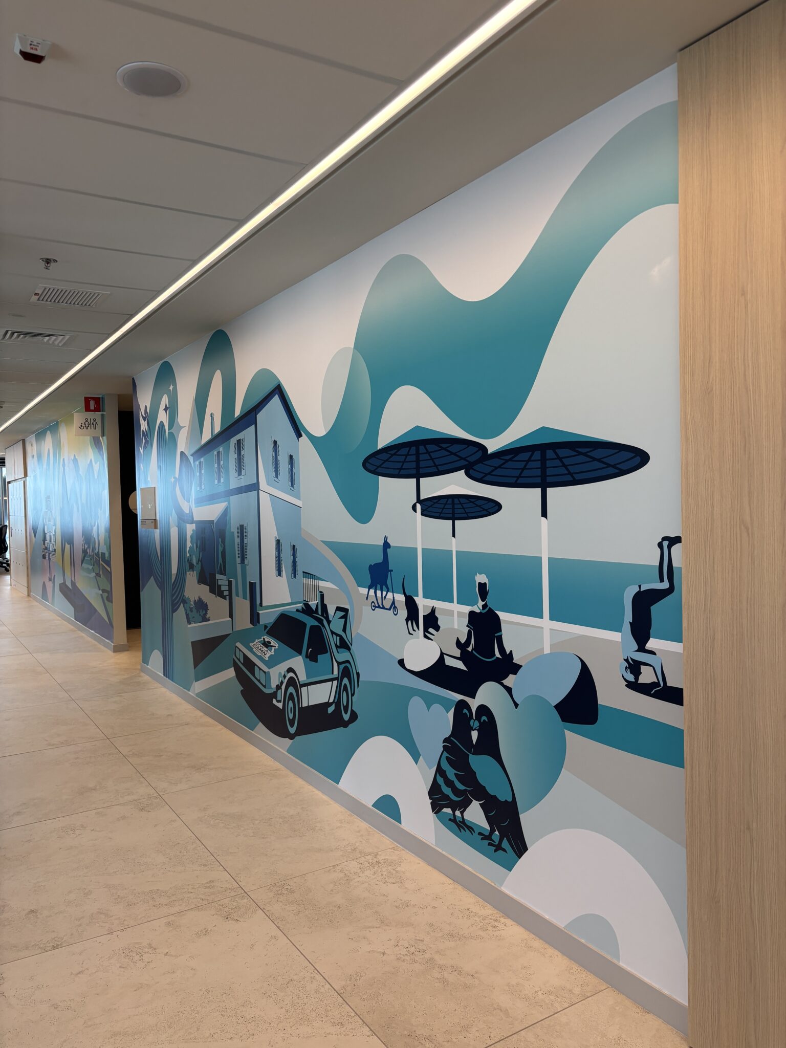 Corridor wall mural of a seaside town in blue tones