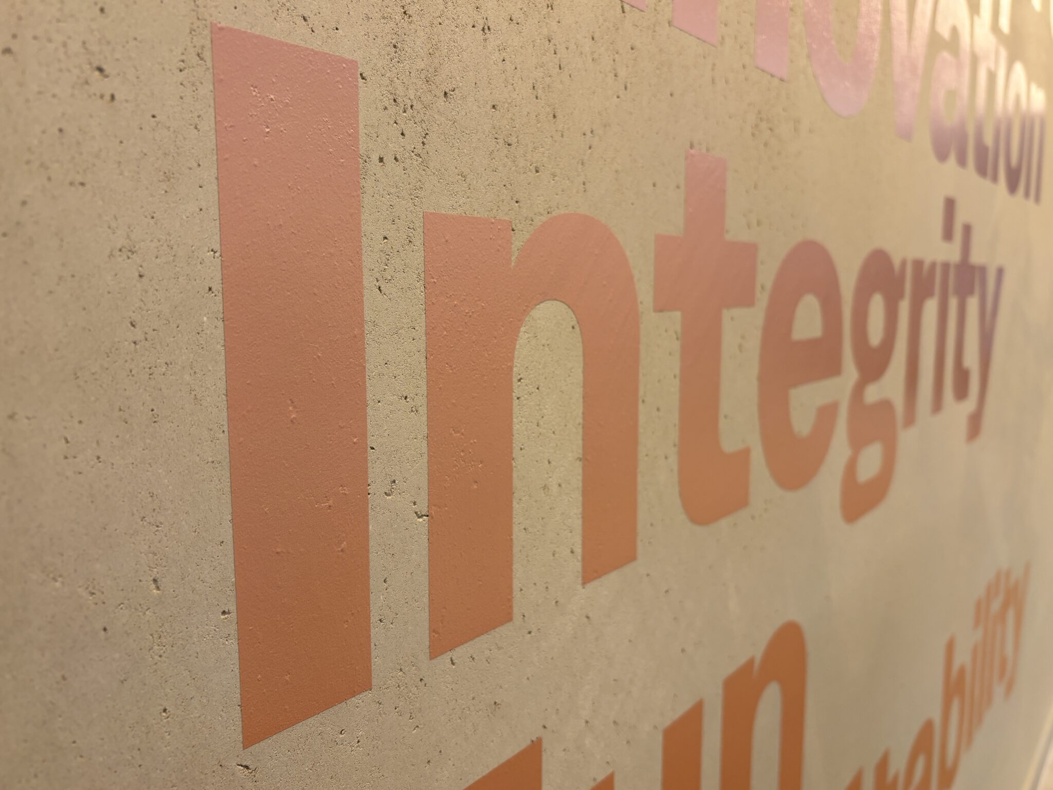 Close-up of Integrity and Innovation value words on a stone wall