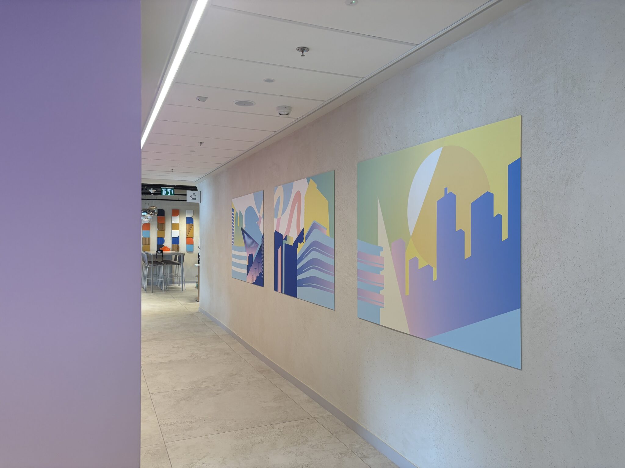 Corridor with framed colourful city skyline prints