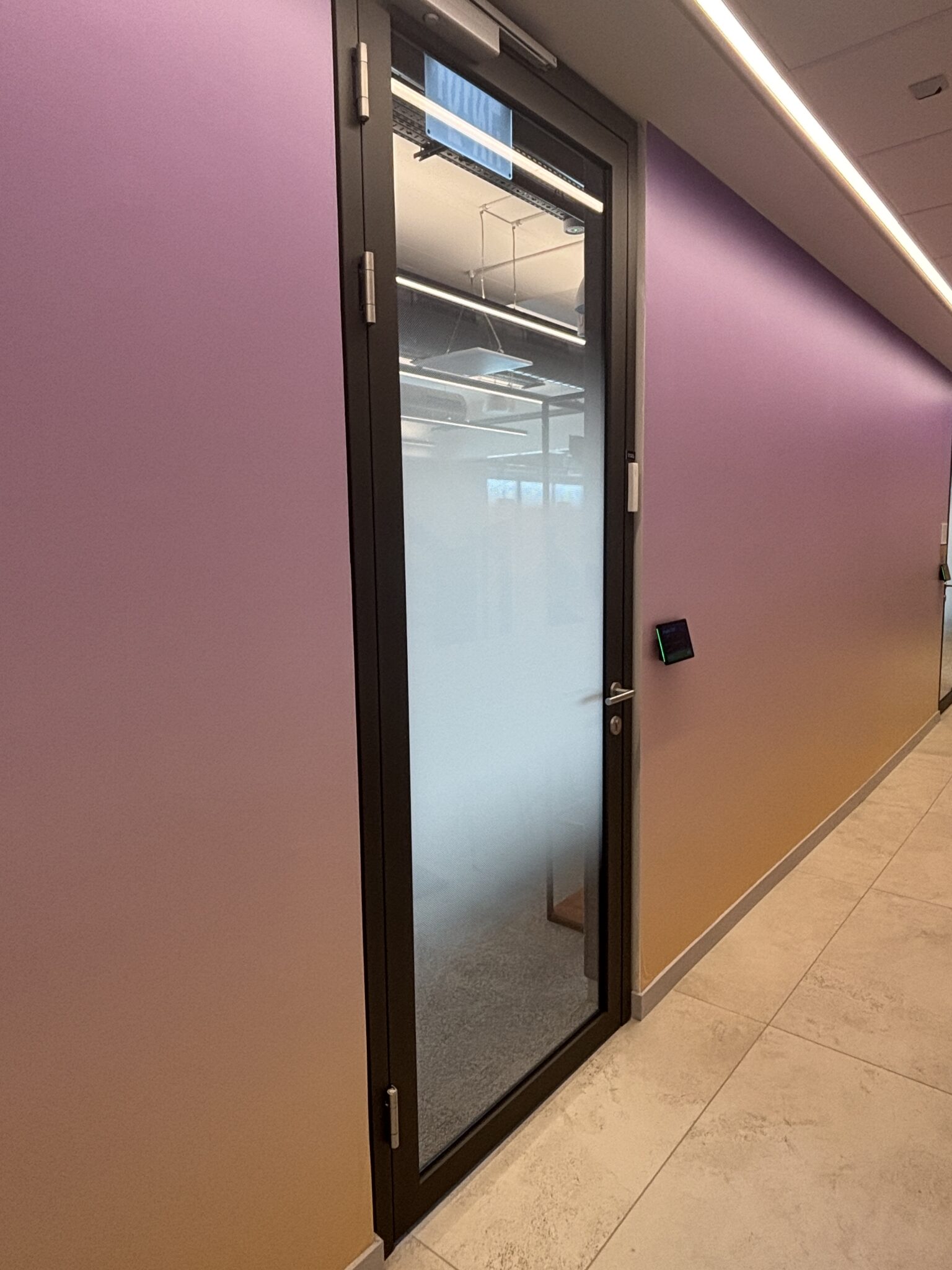 Purple gradient wall beside a glass door