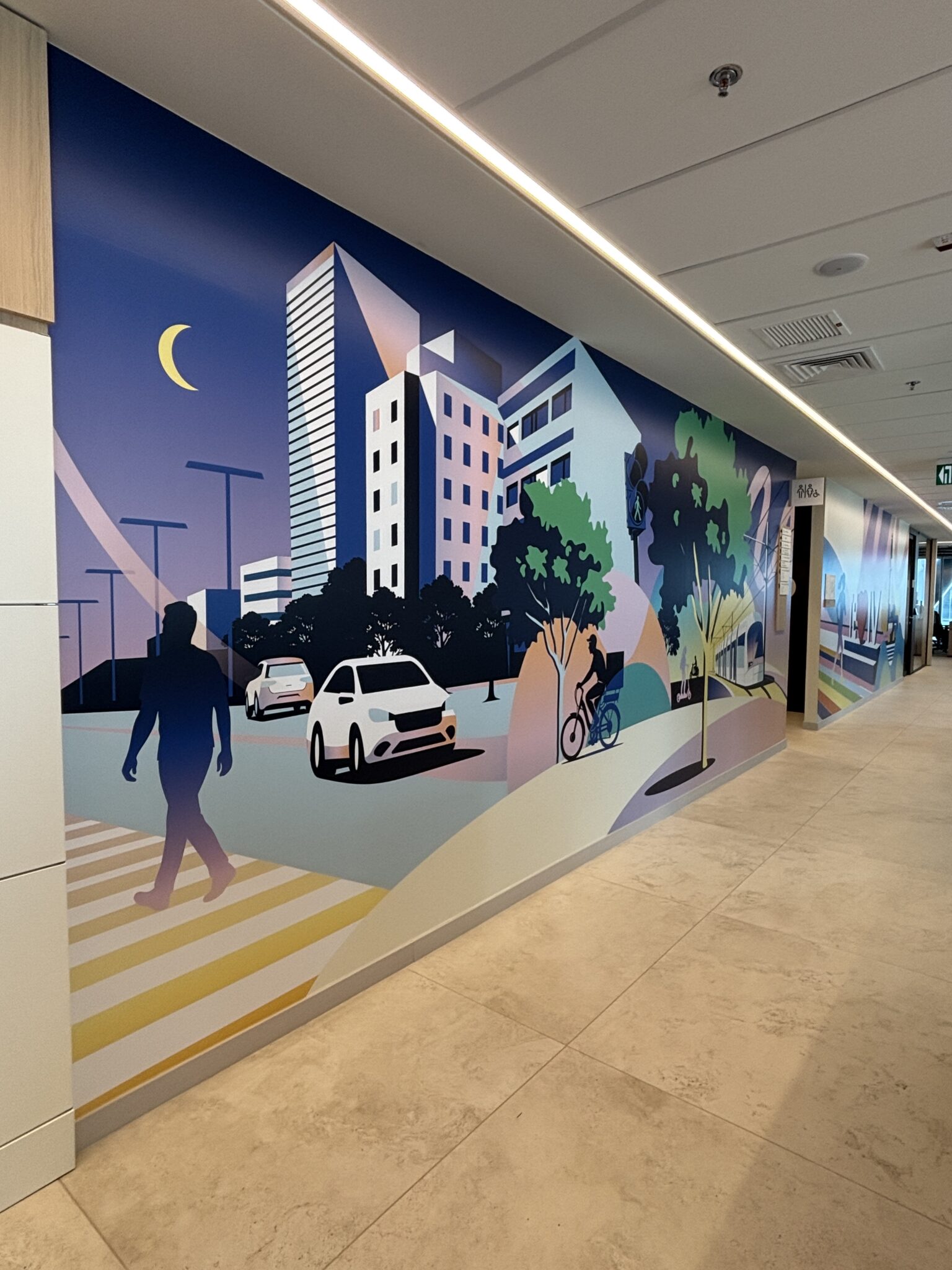 City street illustration mural along an office corridor