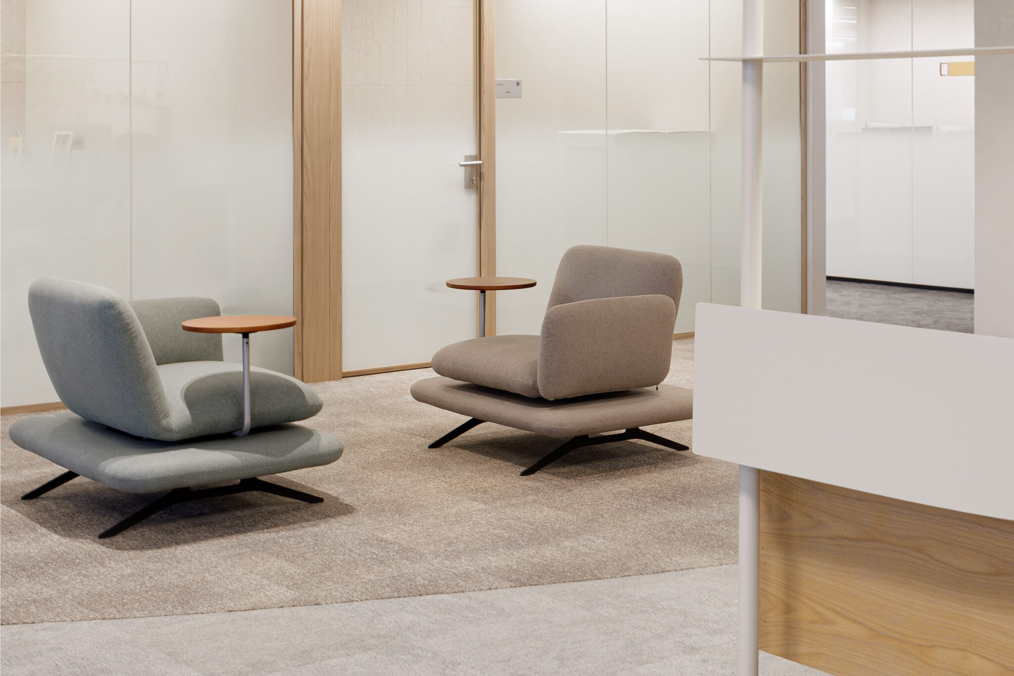 Lounge chairs beside frosted glass offices