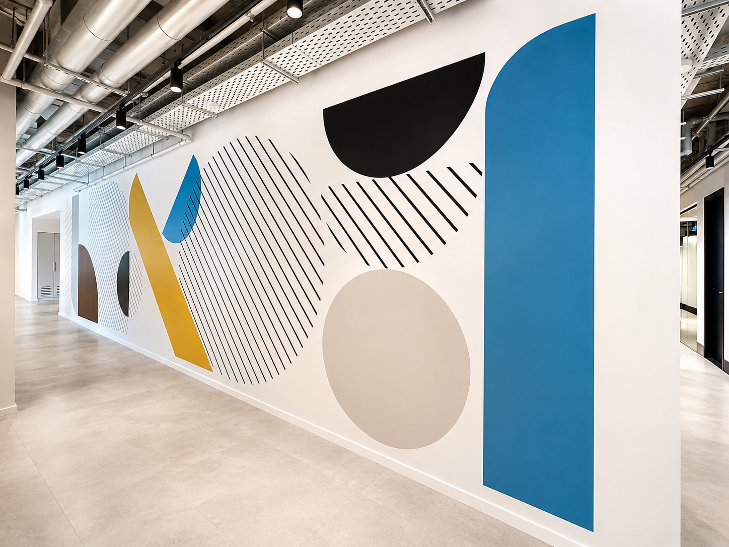 Corridor wall with large blue, black and yellow geometric shapes