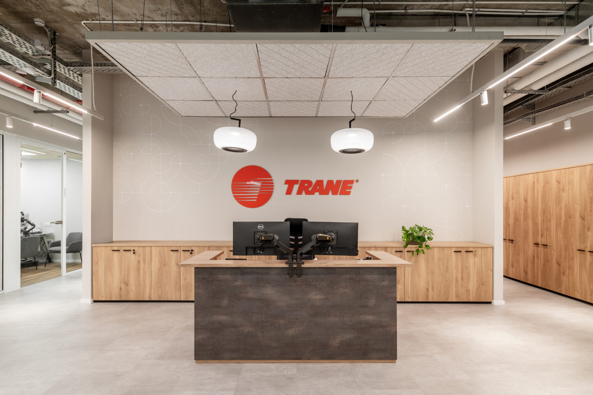TRANE logo on a reception wall behind a stone desk