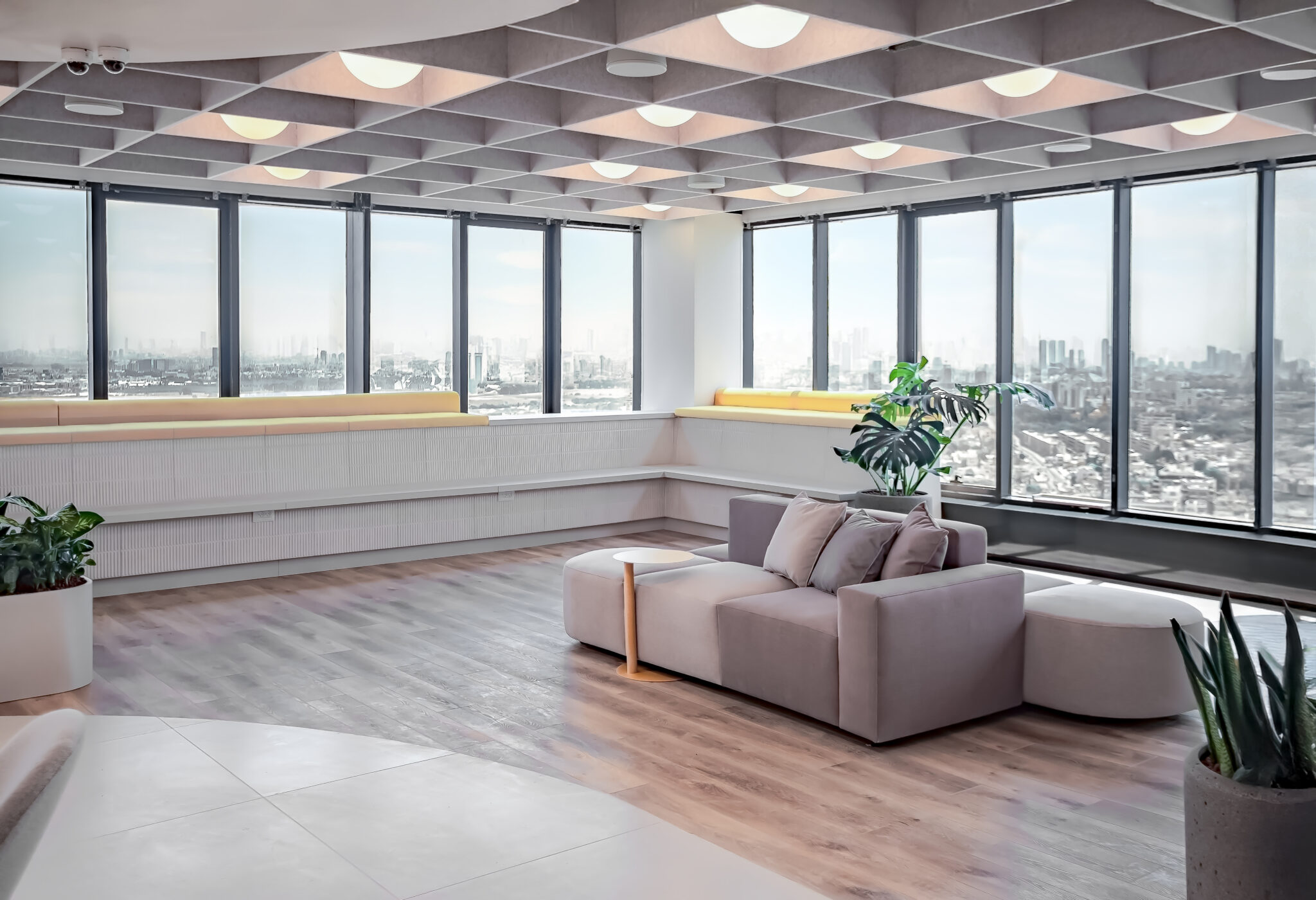 Lounge area with sofas by tall windows and a coffered ceiling